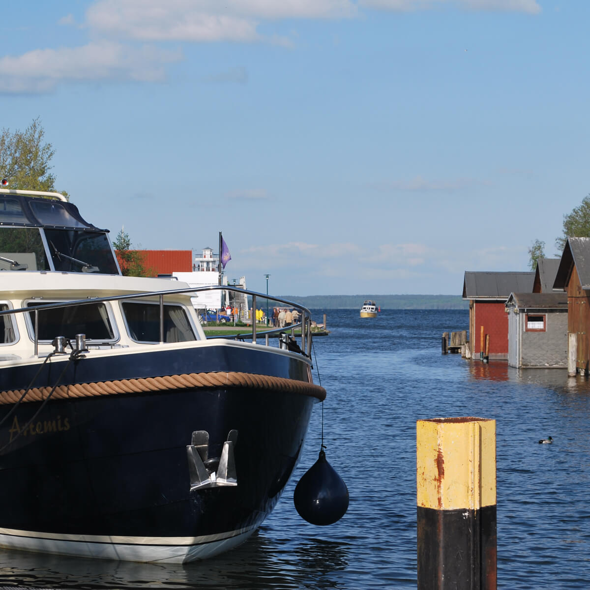 Boote und Yachten im Hafen am Plauer See mit Blick aufs Wasser und Bootshäuser